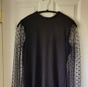 Black elegant top with sheer long sleeves.